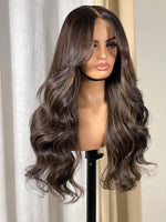 Cargar imagen en el visor de la galería, A brown wig with blond highlights, curtain bangs, and a 5x5 closure displayed on a mannequin head.
